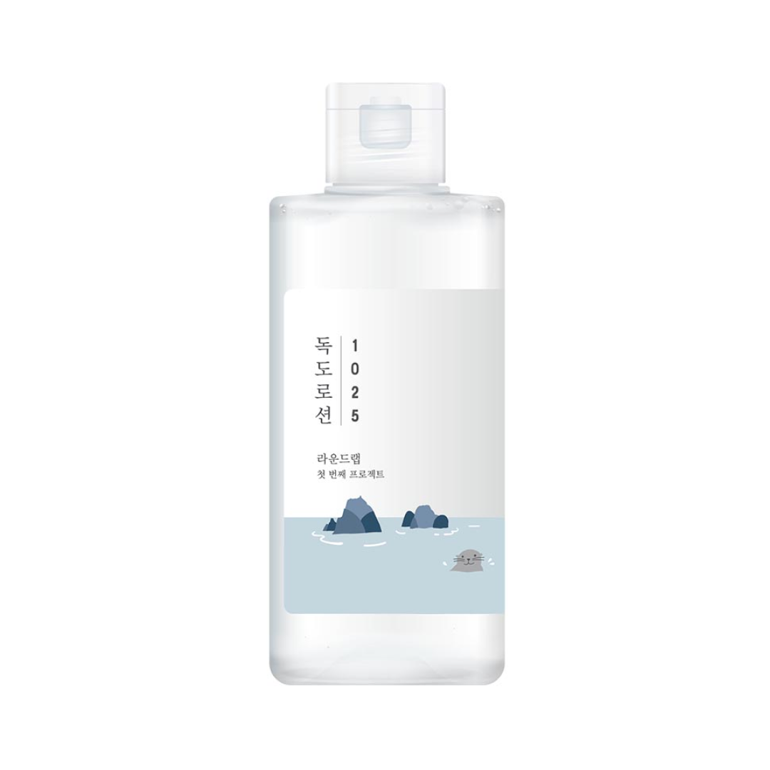 Round Lab Dokdo Lotion in a clear bottle with a minimal white and blue label featuring the Dokdo illustration.